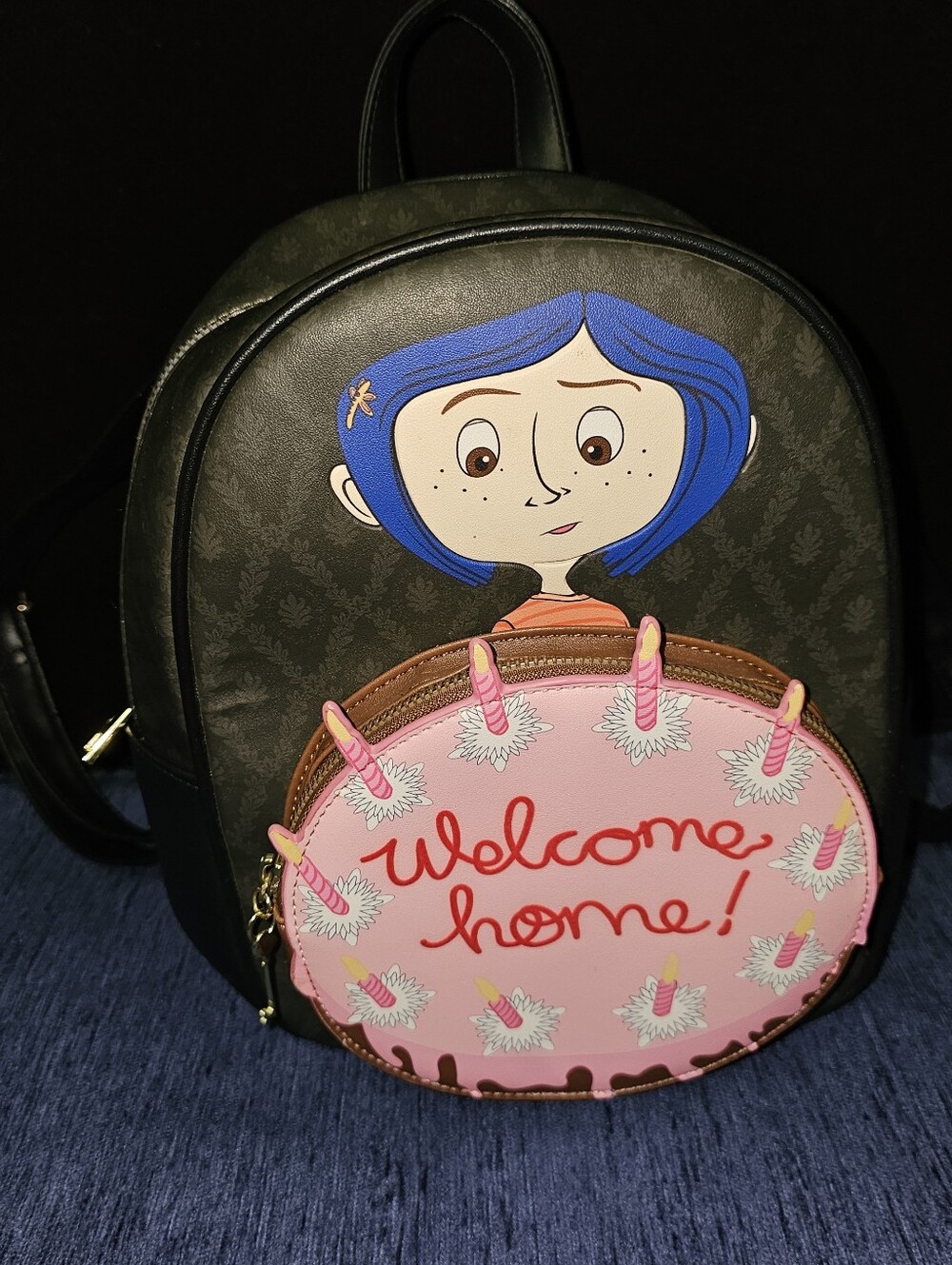 Coraline Hot Topic Black Mini Backpack with Pink 'Welcome Home' Cake Pocket